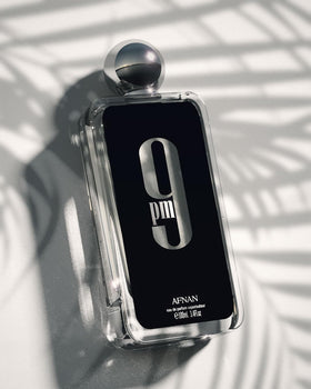 Afnan 9 PM Eau De Parfum displayed on a wooden table