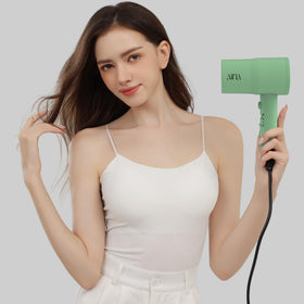 Aina hair dryer in use styling hair