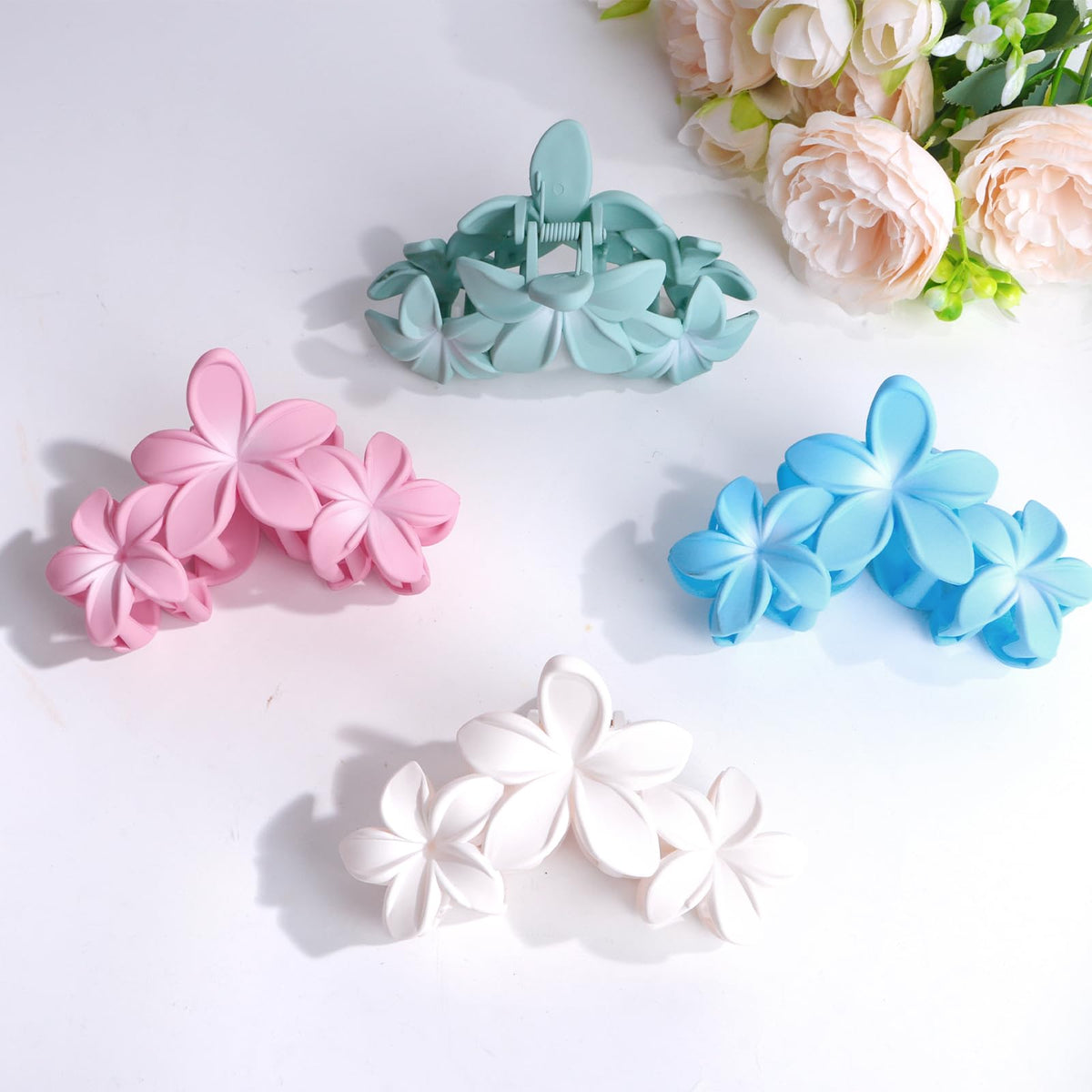 ANBALA Flower Claw Hair Clips displayed on a beach setting