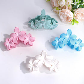 ANBALA Flower Claw Hair Clips displayed on a beach setting