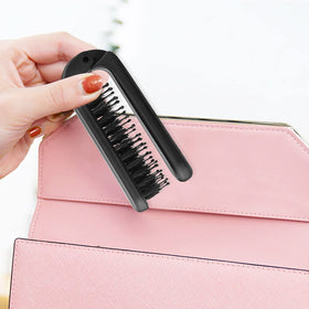 Ancable Travel Folding Hair Brush displayed on a bathroom counter