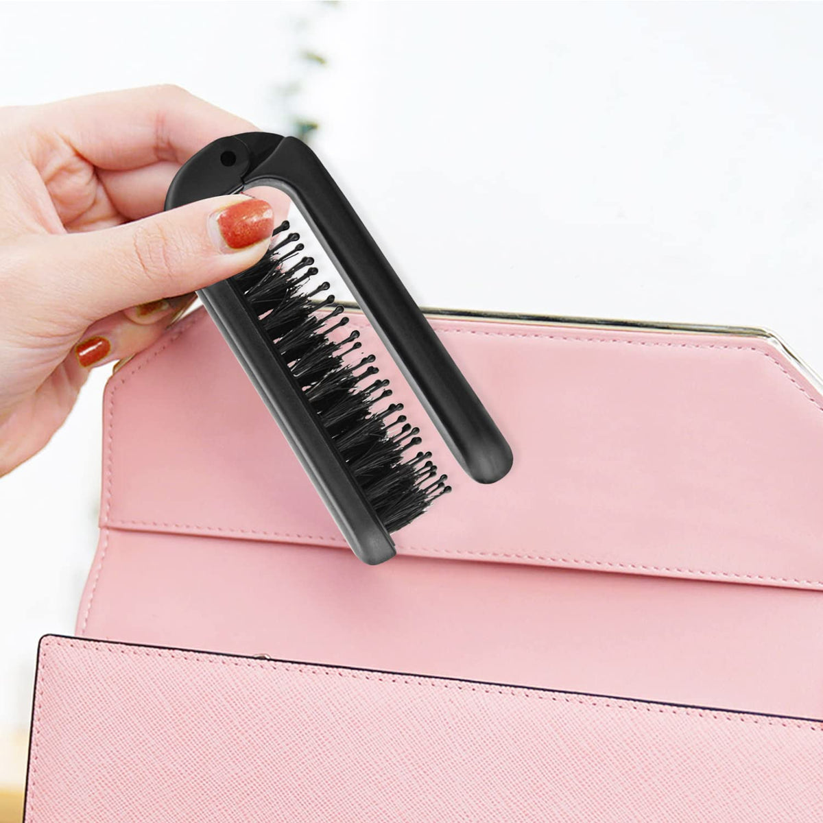 Ancable Travel Folding Hair Brush in use on wet hair