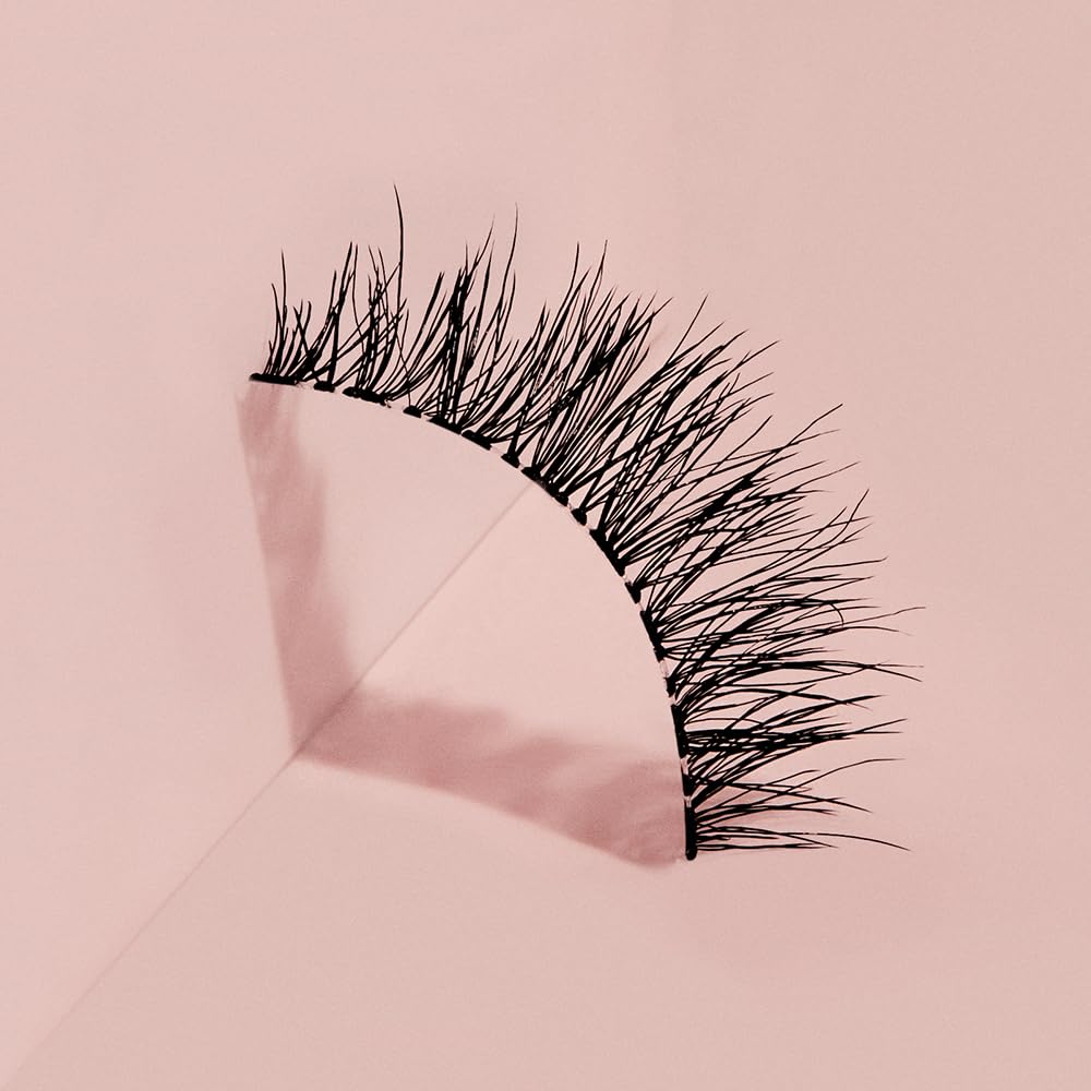 Ardell Naked Lashes 424 displayed with makeup tools