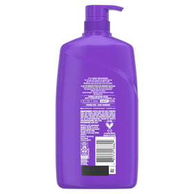 Aussie Miracle Curls Shampoo with citrus and floral background