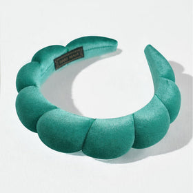 Ayesha Soft Velvet Headband on a vanity with skincare items