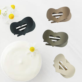 B.PHNE hair claw clips on a bathroom counter during makeup