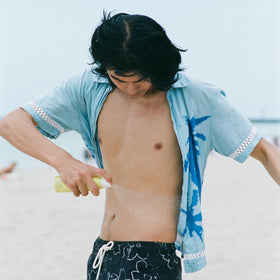 Bask SPF 30 Sunscreen Spray 5.5 oz lifestyle scene at beach