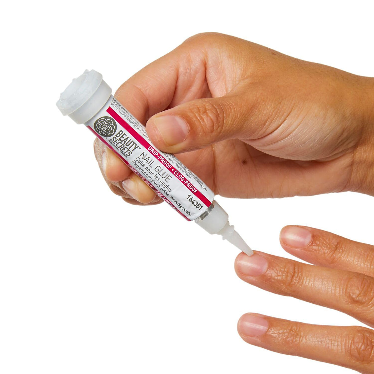 BEAUTY SECRETS Nail Glue pen shown in use on artificial nails