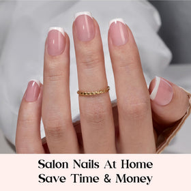 beetles extra short pink press on nails displayed on a hand