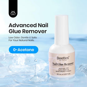 beetles Nail Glue Remover with cuticle pusher on a nail art table