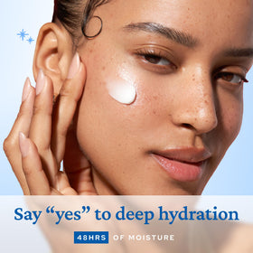belif Moisturizing Bomb with a hand applying cream