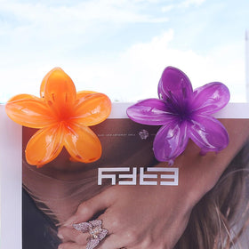 Blue flower claw clip shown in hand