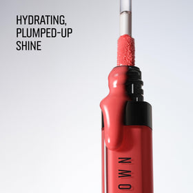Bobbi Brown Crushed Oil-Infused Gloss In the Buff shade on a makeup table