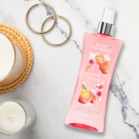 Body Fantasies Sugar Peach Body Spray 8 fl oz on a vanity