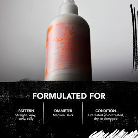 Bumble and bumble. Hairdresser's Invisible Oil Leave-In Conditioner on a bathroom shelf