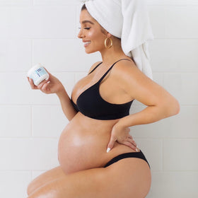 Bumpology Bump Butter 4 oz on a bathroom shelf