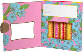 Burt's Bees lip balm tubes displayed on a wooden surface