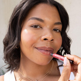Burt's Bees Shimmer Lip Tint Set displayed on a vanity