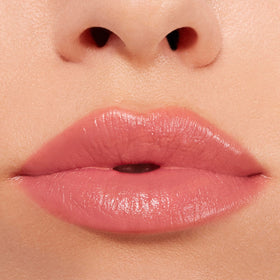 Buxom Power-Full Plumping Lip Balm Inner Glow applied on lips