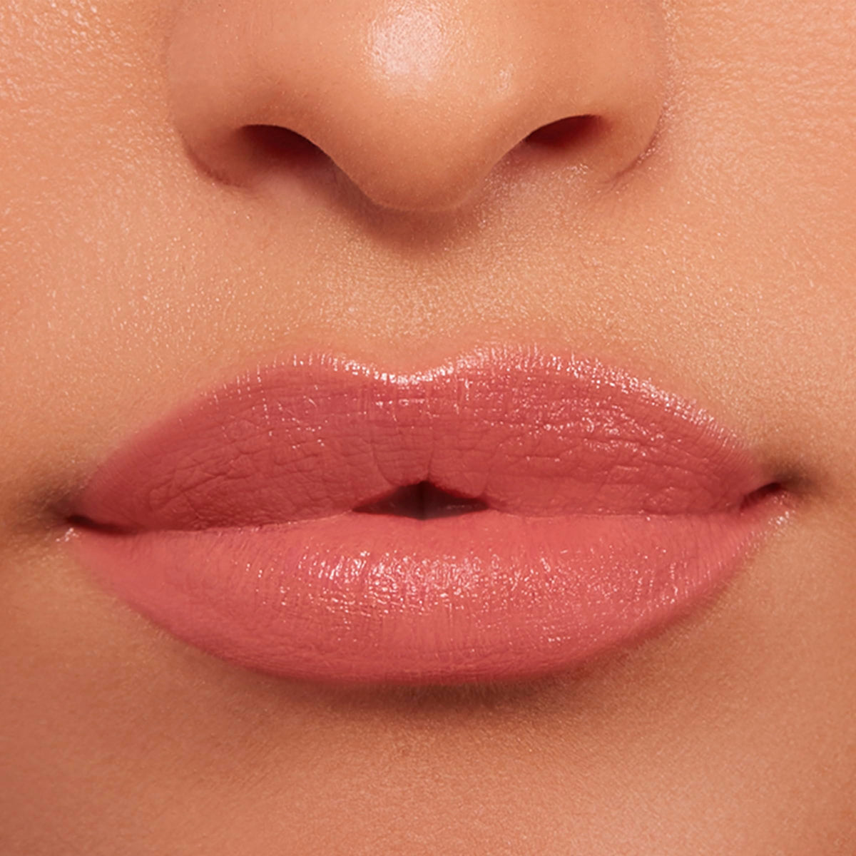 Buxom Power-Full Plumping Lip Balm Inner Glow with natural lighting