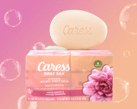 Caress Daily Silk Moisturizing Soap bars on a wooden surface