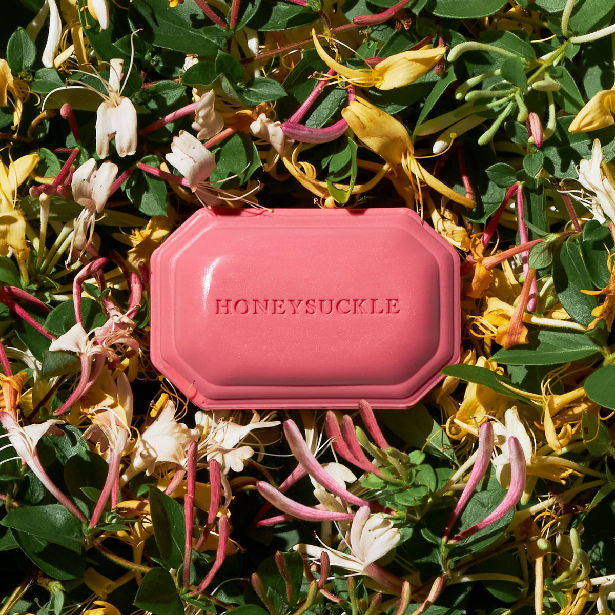 Caswell-Massey Honeysuckle Natural Bar Soap with floral background