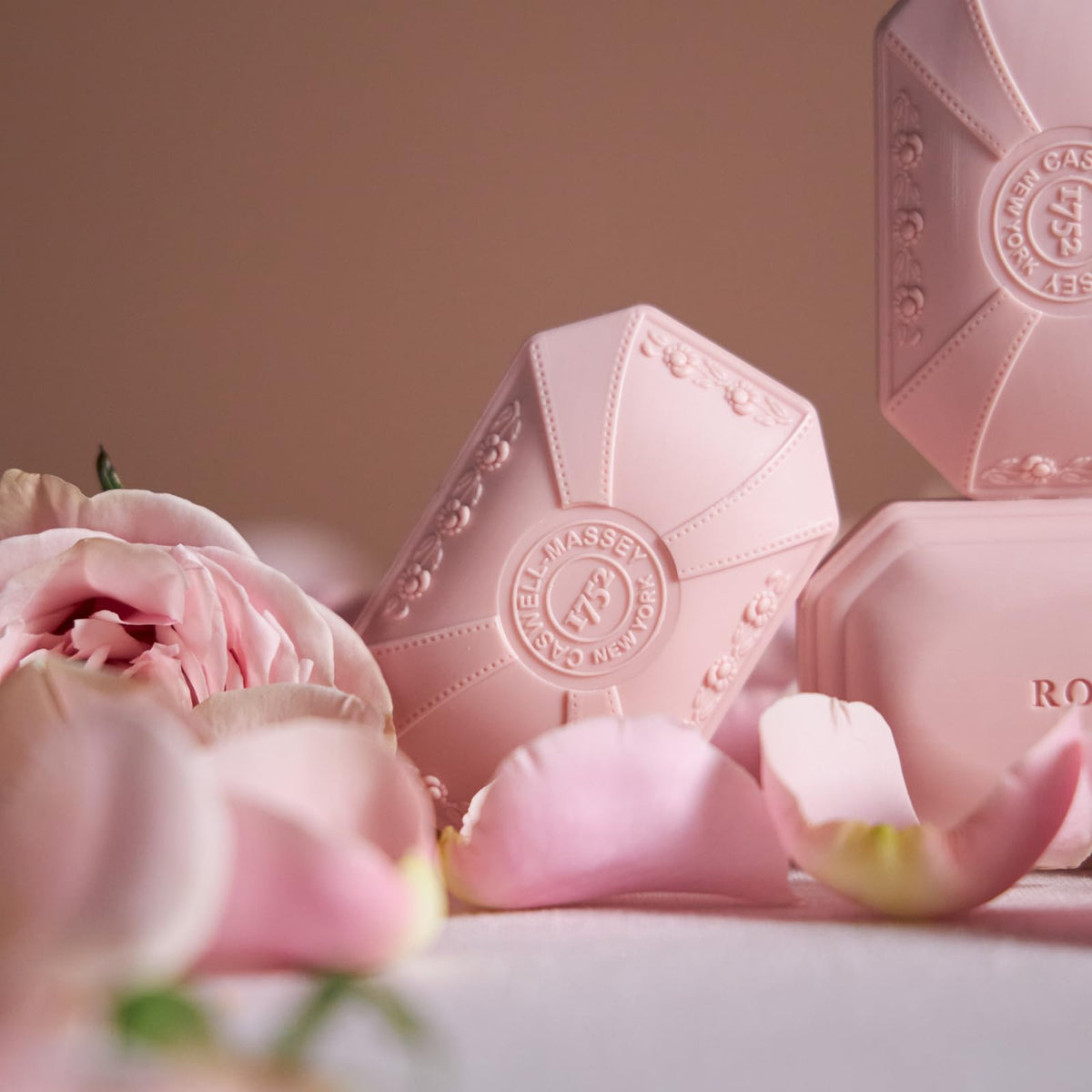 Caswell-Massey Rose Natural Bar Soap on a wooden soap dish