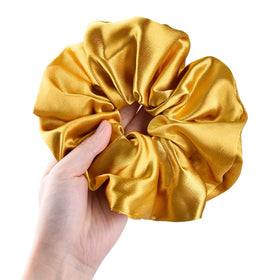 CEELGON gold satin scrunchie arranged with other accessories