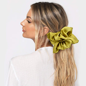 CEELGON silk scrunchie in champagne colour on a wrist