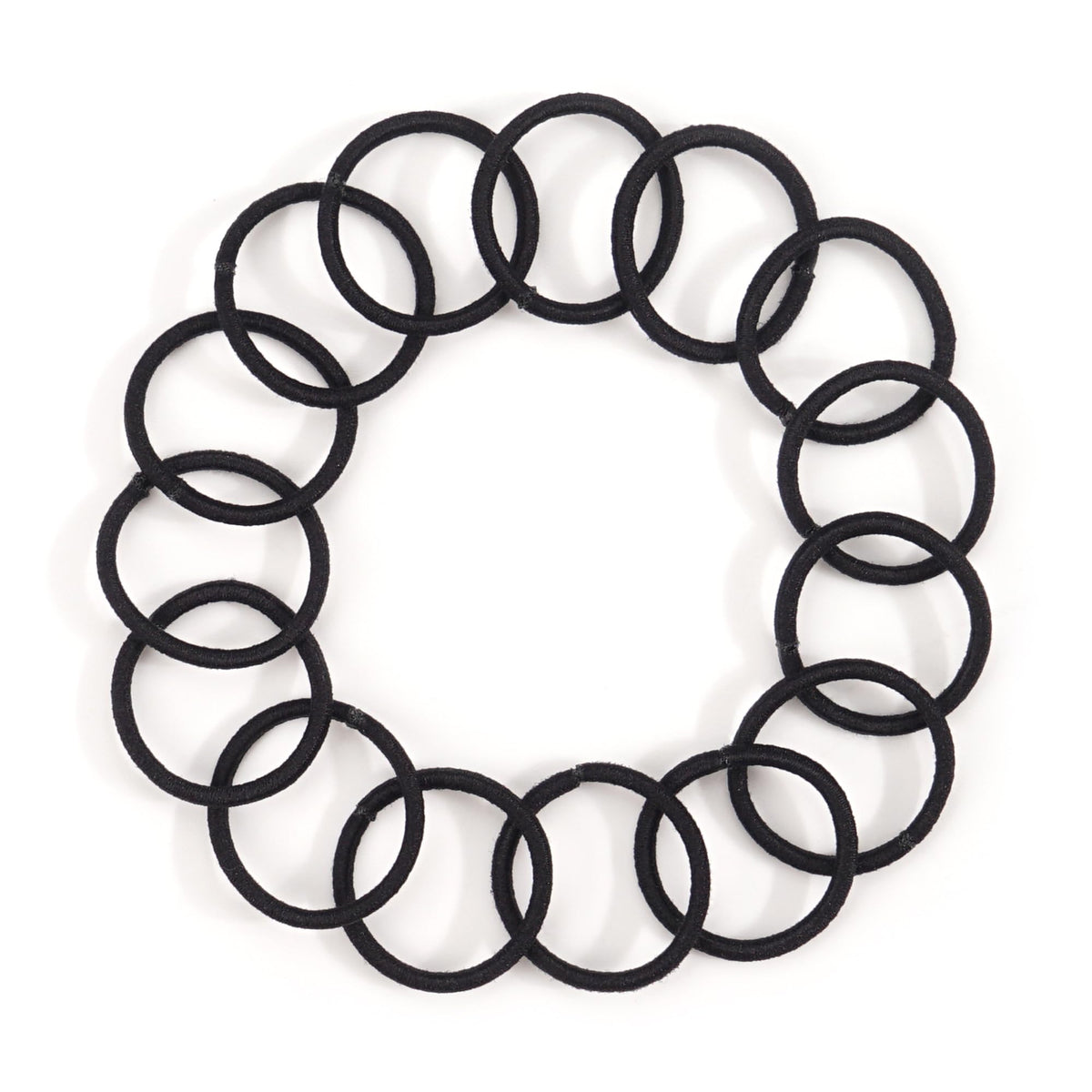 CÉLLOT black elastic hair ties on a flat surface