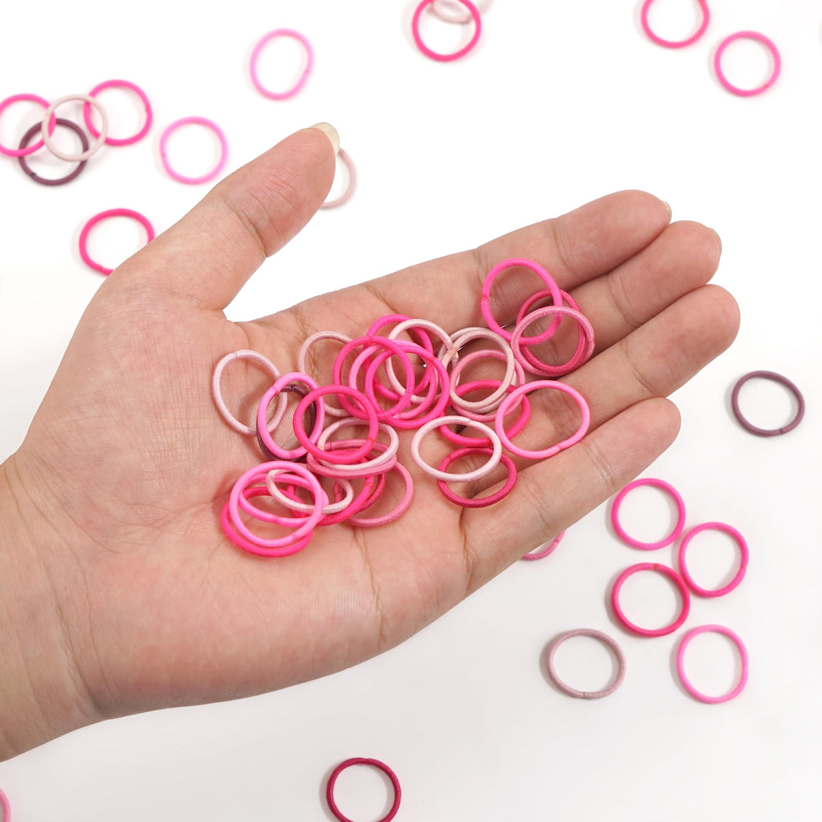 CÉLLOT hair ties arranged in a rainbow pattern