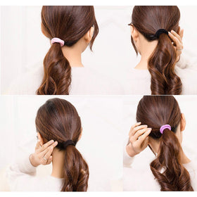 CÉLLOT Hair Ties in use by a woman during workout