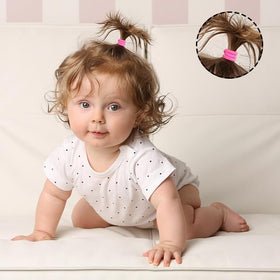 CÉLLOT hair ties in use on a toddler's hair