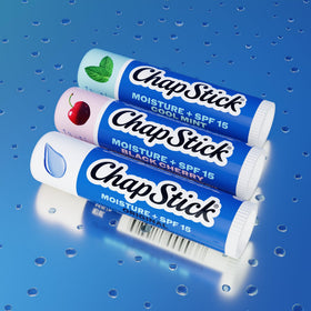 ChapStick Moisture + SPF 15 lip balm on a beach setting