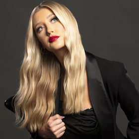 CHI Dry Shampoo 2.6 Oz in hand demonstrating usage