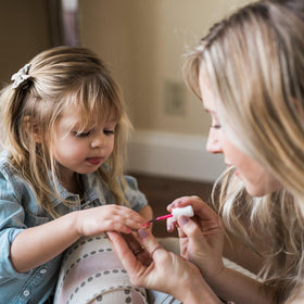 Child enjoying nail painting with Piggy Paint products