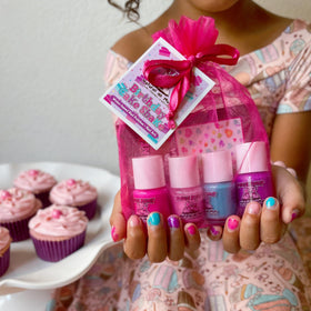 Child's hands showing off colourful nails using Piggy Paint polish