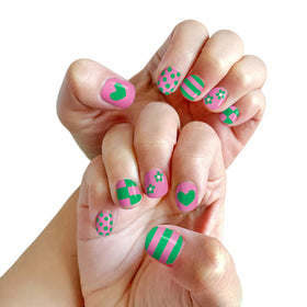 Child showing off colourful nails painted with Piggy Paint