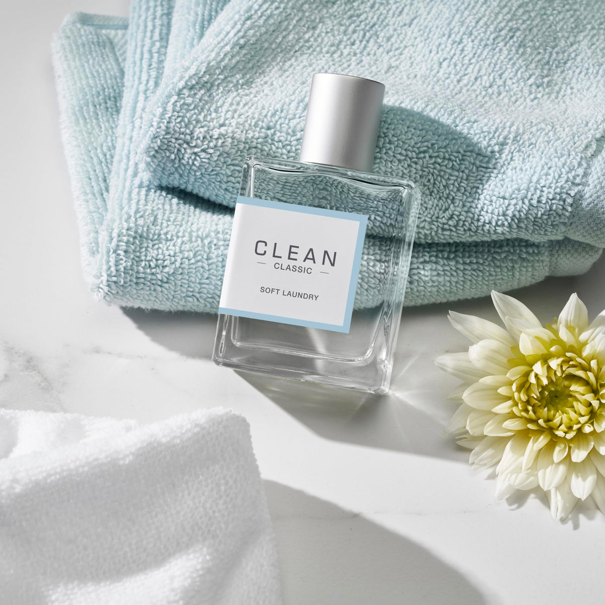 CLEAN Soft Laundry Eau de Parfum 60mL with floral background