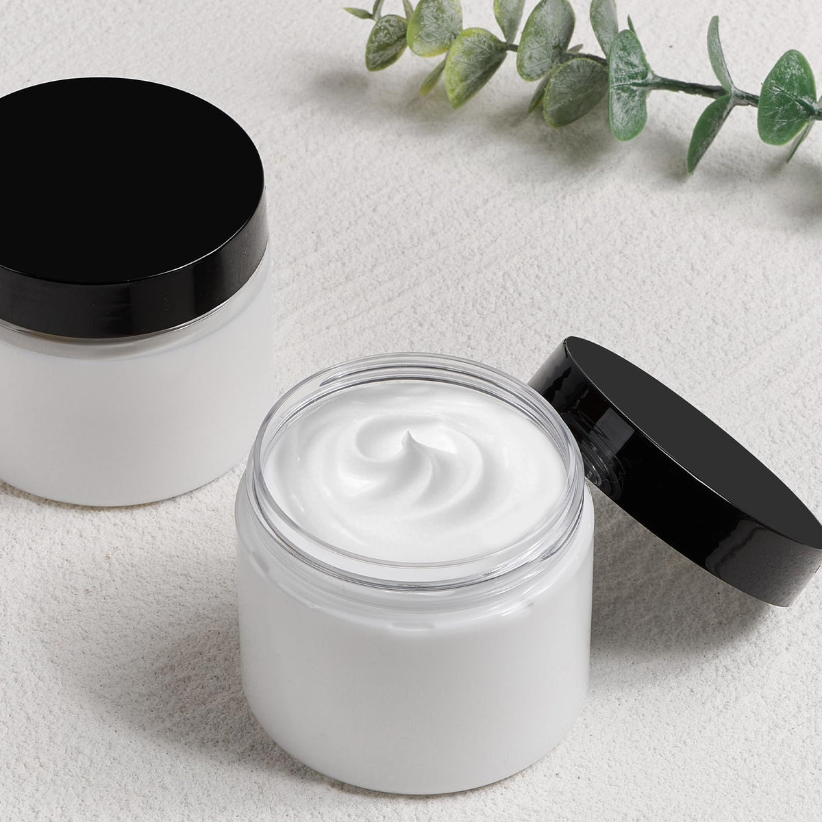 Clear TUZAZO plastic container filled with lotion