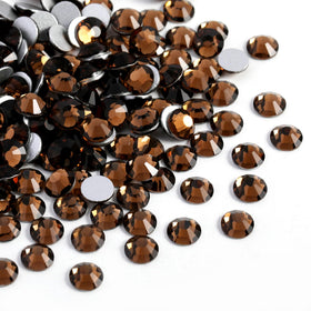 Close-up of BEADSLAND Smoked Topaz rhinestones on a craft surface