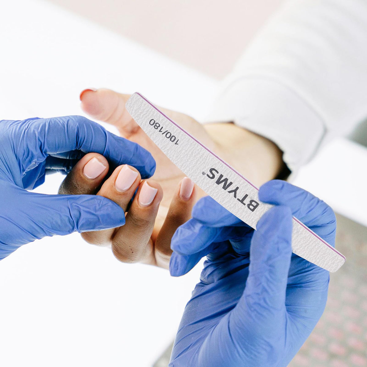 Close-up of BTYMS nail file in use on natural nails