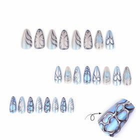 Close-up of CTTHNBD blue press on nails showcasing bow heart design