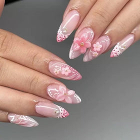 Close-up of CTTHNBD pink almond press on nails with floral design