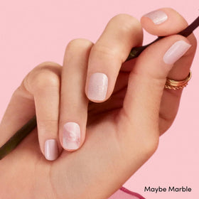 Close-up of Dashing Diva gel nail strips showing application process