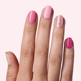 Close-up of Dashing Diva nail strips in various pink shades
