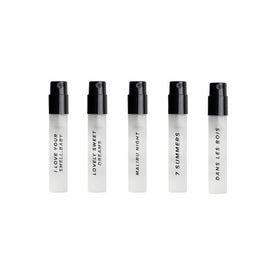 Close-up of DIME travel size perfume bottles in the sampler kit