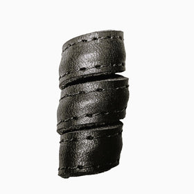 Close-up of handcrafted leather hair bead showing texture