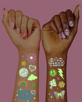 Close-up of iridescent foil hand-drawn designs on tattoo sheets