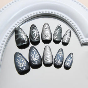 Close-up of KRTBKR Goth Press On Nails showing glitter detail